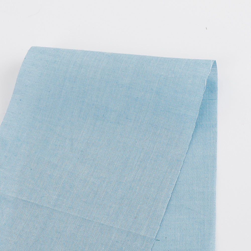 // A classic lightweight cotton chambray in a sky blue. Perfect for tailored shirts, summer shorts and dresses. 